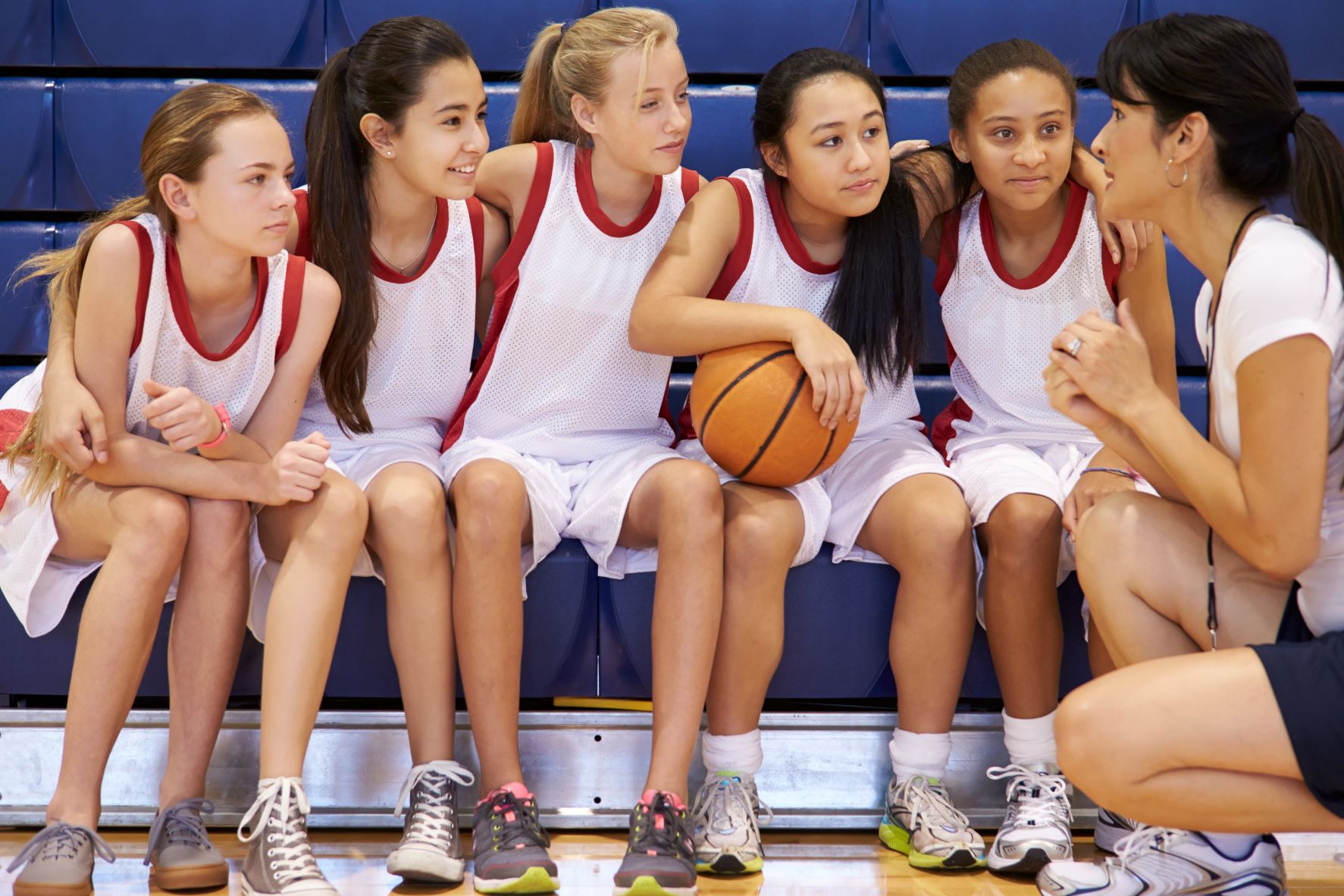 Photo of girls basketball on a bench 